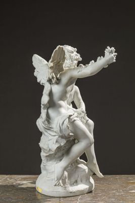 a statue of a woman sitting on a rock