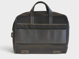 the large black bag is sitting on a white surface