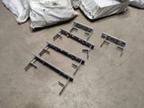several pieces of metal are laying on the floor in a warehouse
