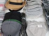 many hats that are on a table in a store