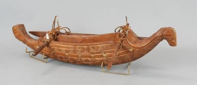 a wooden boat that is on display on a table