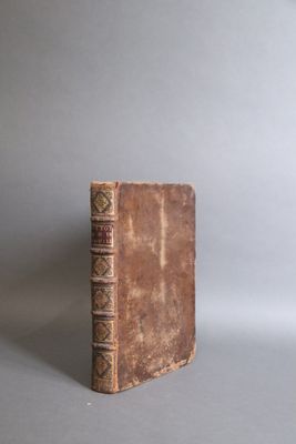an old book sitting on top of a gray surface