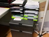 a desk with a lot of files on it and a lamp