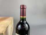 a bottle of wine sitting next to a wooden box