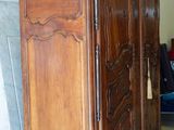 a large wooden armoire in the middle of a room