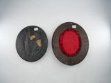 pair of red and black plates on a white surface