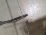 a knife that is laying on the floor in the bathroom