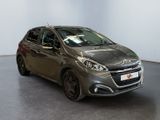 the grey car is parked in a large room with a black floor