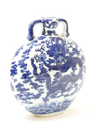 a blue and white vase with a dragon design on it