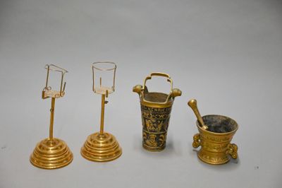 three different types of brass items are displayed on a white surface