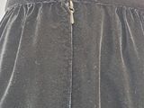 the back of a woman ' s skirt with a zipper down the side