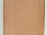 a wooden box with holes in it sitting on a white surface