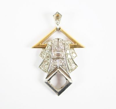 a close up of a diamond and gold pendant on a white background