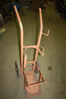 a small cart with a handle in the middle of a room