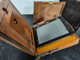 an old wooden box with a glass in it
