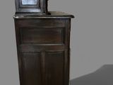 a small wooden cabinet with a mirror on top of it