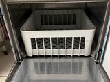 a dishwasher with a basket in it in a kitchen