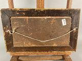 an old wooden easel with a piece of wood on top of it