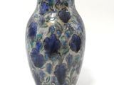 a blue and white vase sitting on a white surface