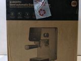 the box is open to show the contents of a coffee machine