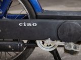 a close up of a blue motorcycle with a black seat