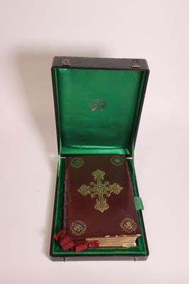 a small green box with a book inside of it