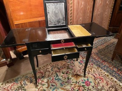 a small desk with a mirror on top of it