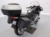 a black and silver motorcycle parked in a white room