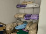 a closet full of pillows and other items in the room