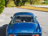 a blue car that is parked on the side of the road