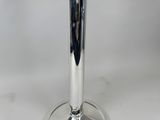 a silver candle holder on a table with a white background