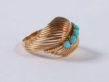 a close up of a gold ring with turquoise stones on it