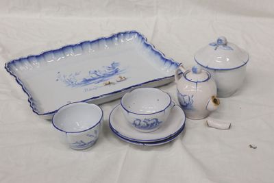 several pieces of blue and white porcelain on a white table cloth