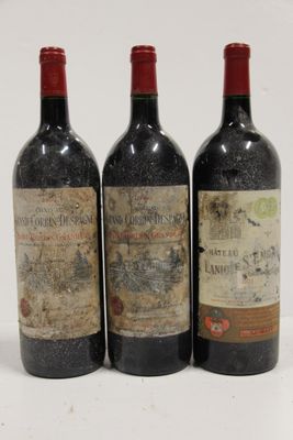 three bottles of wine are lined up on a white surface