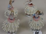 three porcelain figurines of a woman in a dress and a man in a tutu