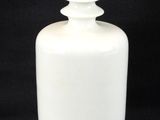 a white bottle that is sitting on a black background