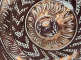 a close up of a plate with a spiral design on it