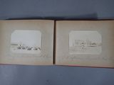 an old book opened to show two pictures of a building