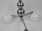 a metal object with three balls on top of it