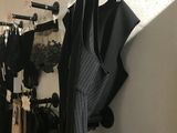 a picture of a room with clothes hanging on the wall