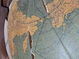 a close up of an old globe on a table