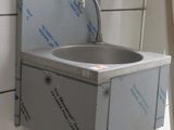 une photo d'une salle de bains avec un lavabo et une échelle