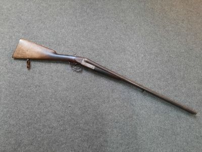 a rifle that is laying on top of a table