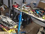 an image of a garage with a lot of junk on the floor