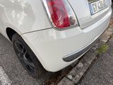 a white car that is parked on the side of the street