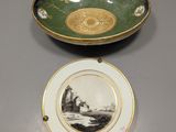 a green and gold plate with a picture of a castle on it