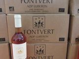 des bouteilles de vin posées sur une table en bois, à côté de cartons de vin