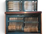 a wooden box with a bunch of silverware in it