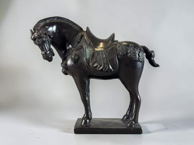 a statue of a horse with a saddle on it ' s back