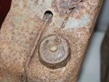 a close up of a piece of metal with a chain on it